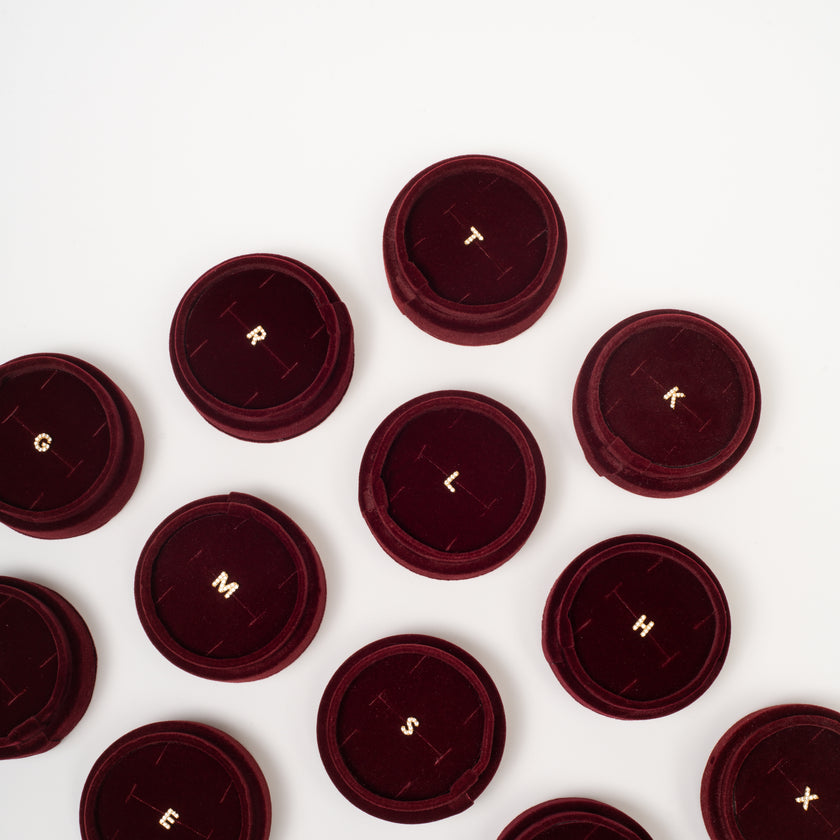 Single abc Stud Earrings in velvet tube packaging