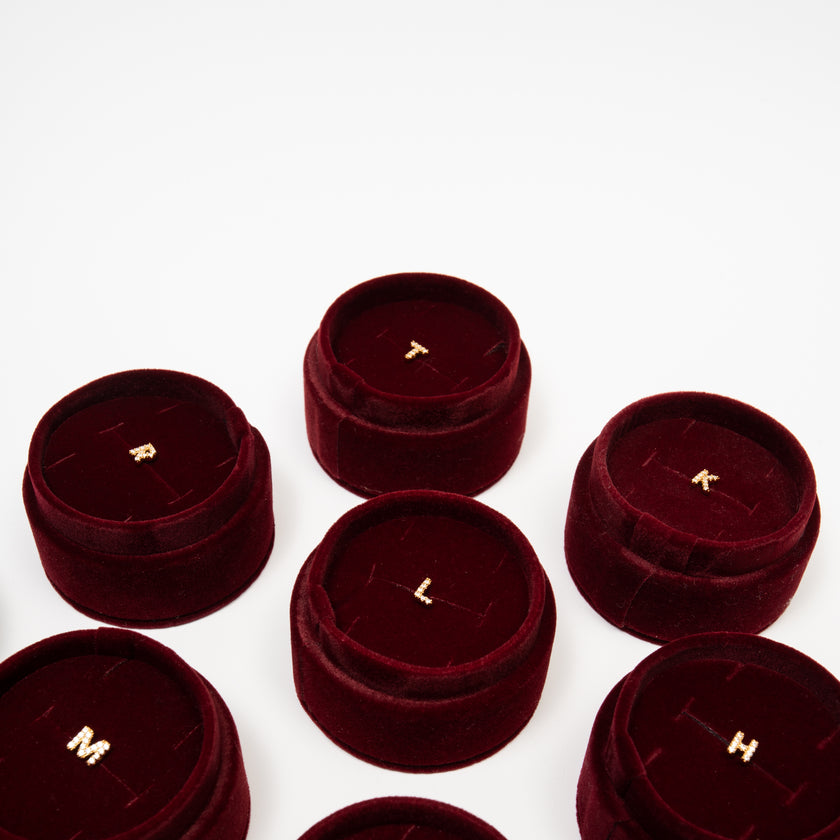 Single abc Stud Earrings in velvet tube packaging