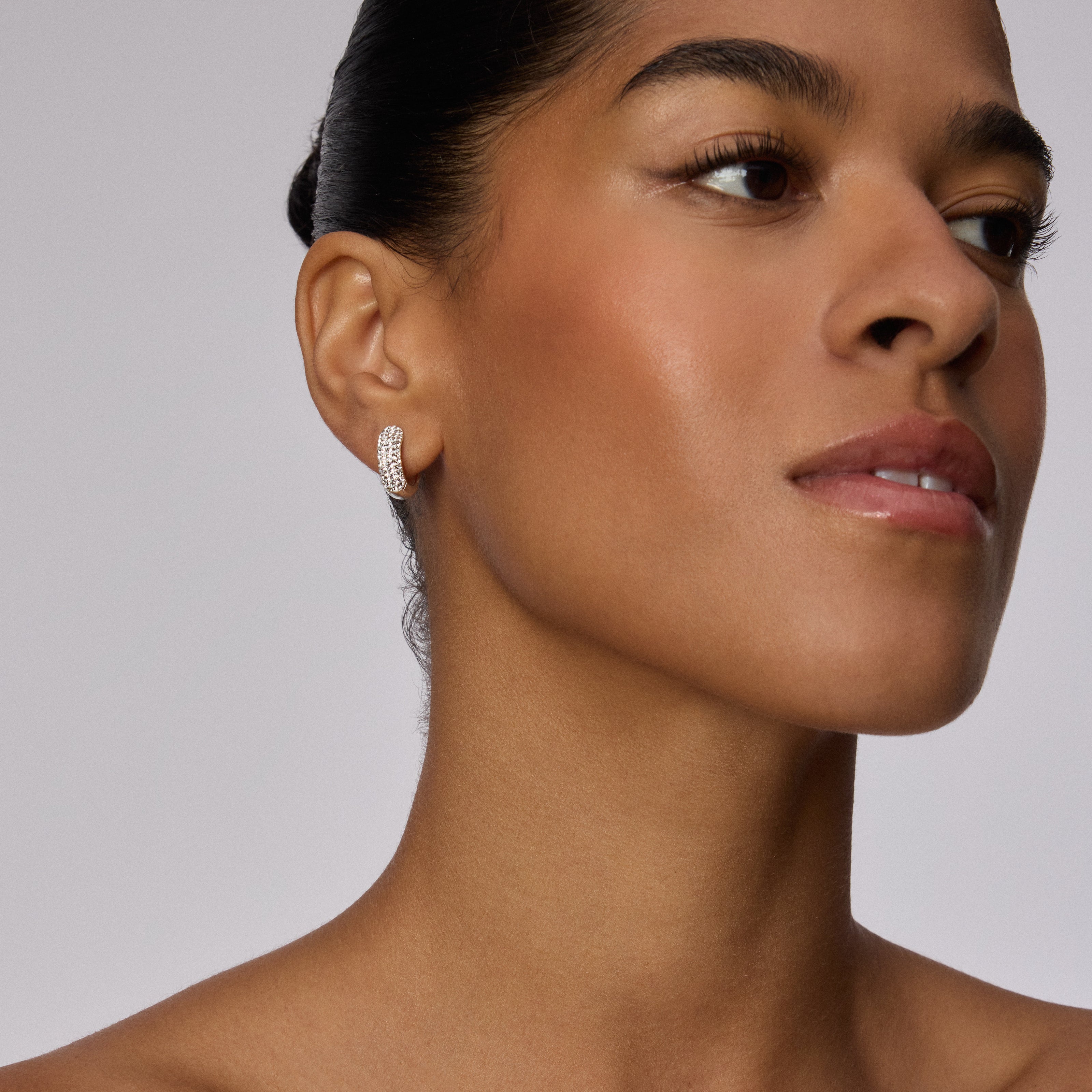 White Starburst Sparkle Reversible Hoop Earrings on model