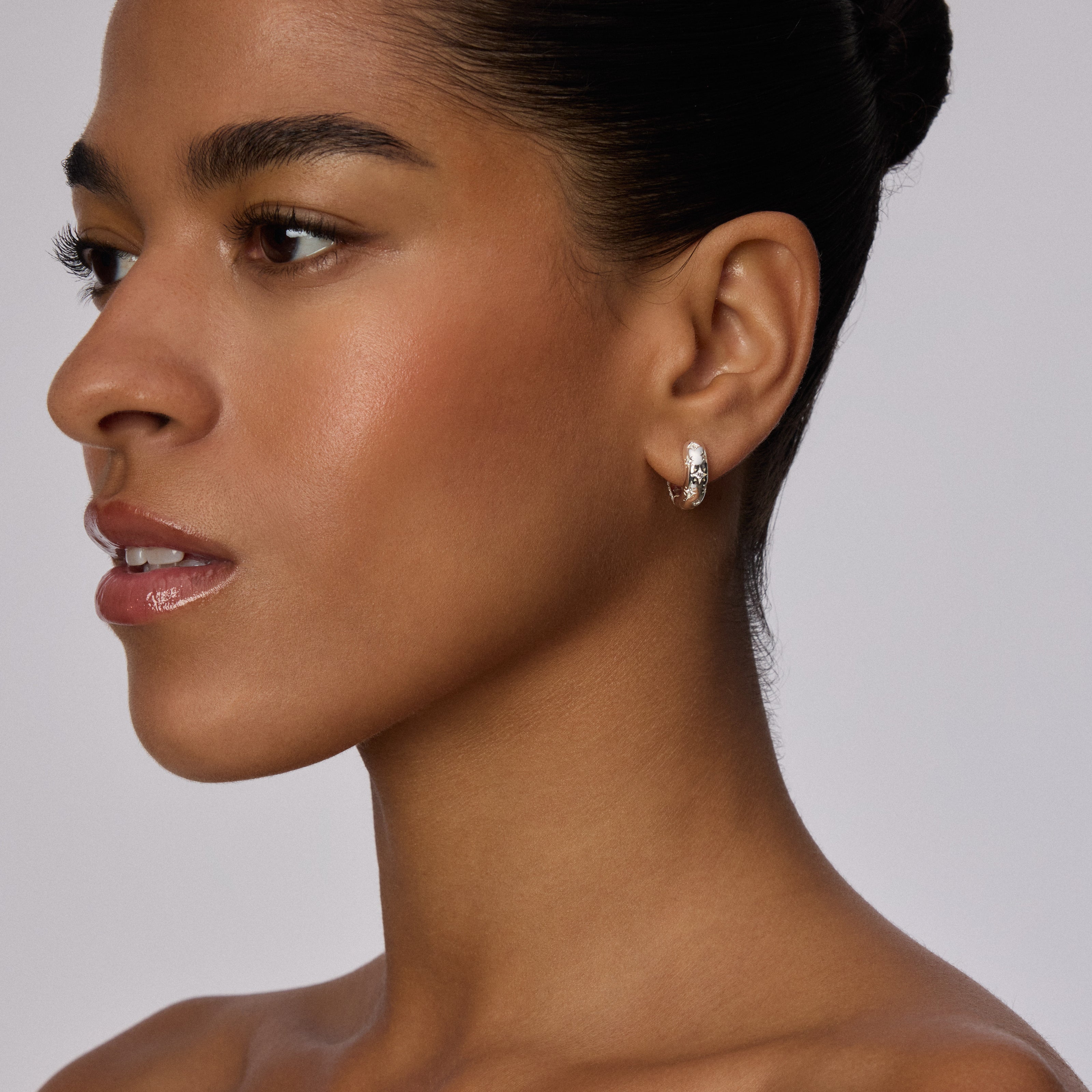Silver Starburst Sparkle Reversible Hoop Earrings on model
