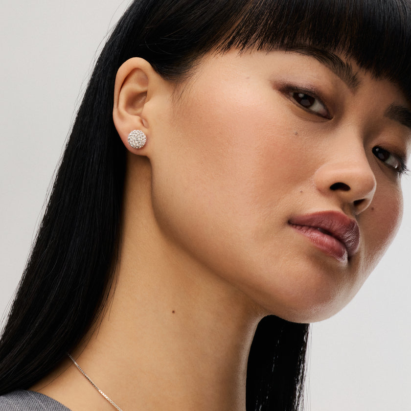 White Medium Sparkle Ball™ Stud Earrings on model