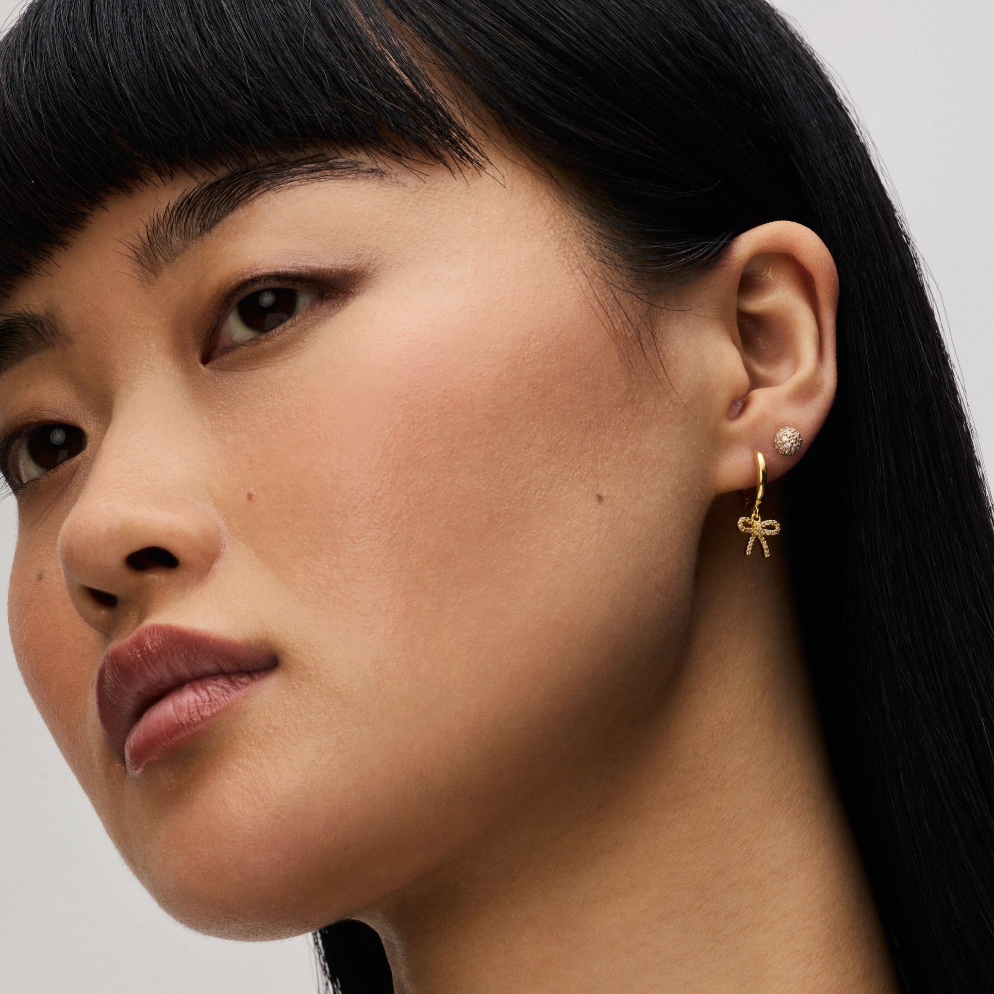 Baby Bow Hoop Earrings on model