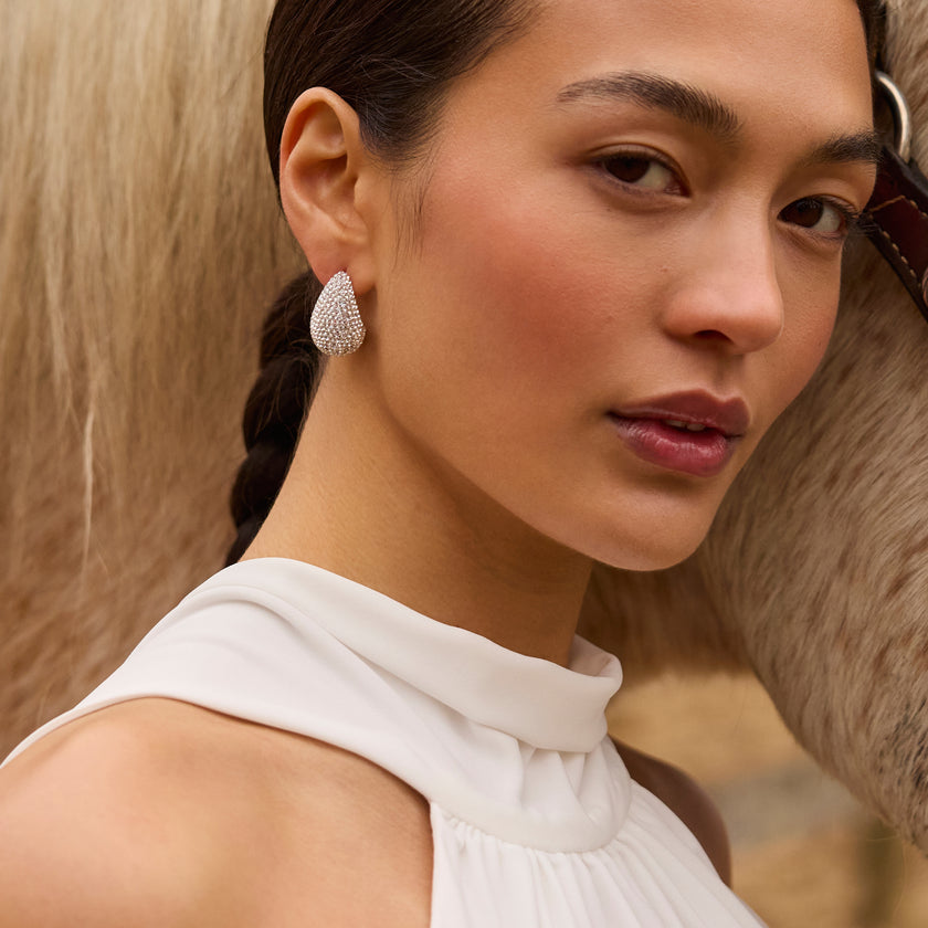 White Dream Puff™ Sparkle Stud Earrings on model