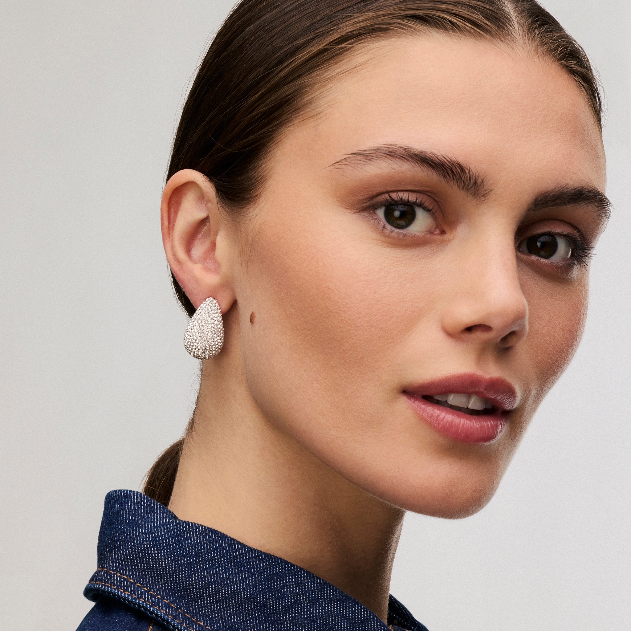 White Dream Puff™ Sparkle Stud Earrings on model