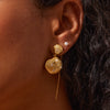 Golden Shell Drop Earrings close up on model