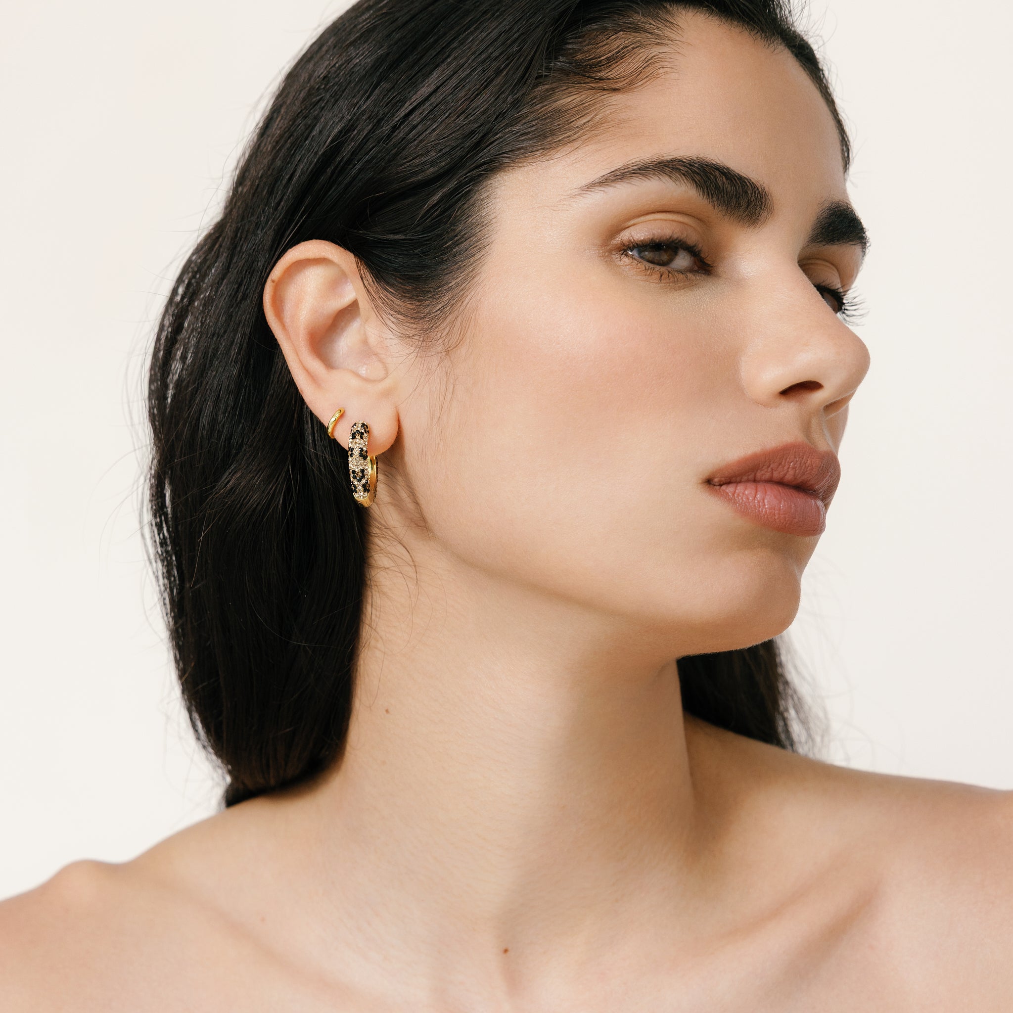 Leopard/Espresso Medium Reversible Sparkle Hoop Earrings on model