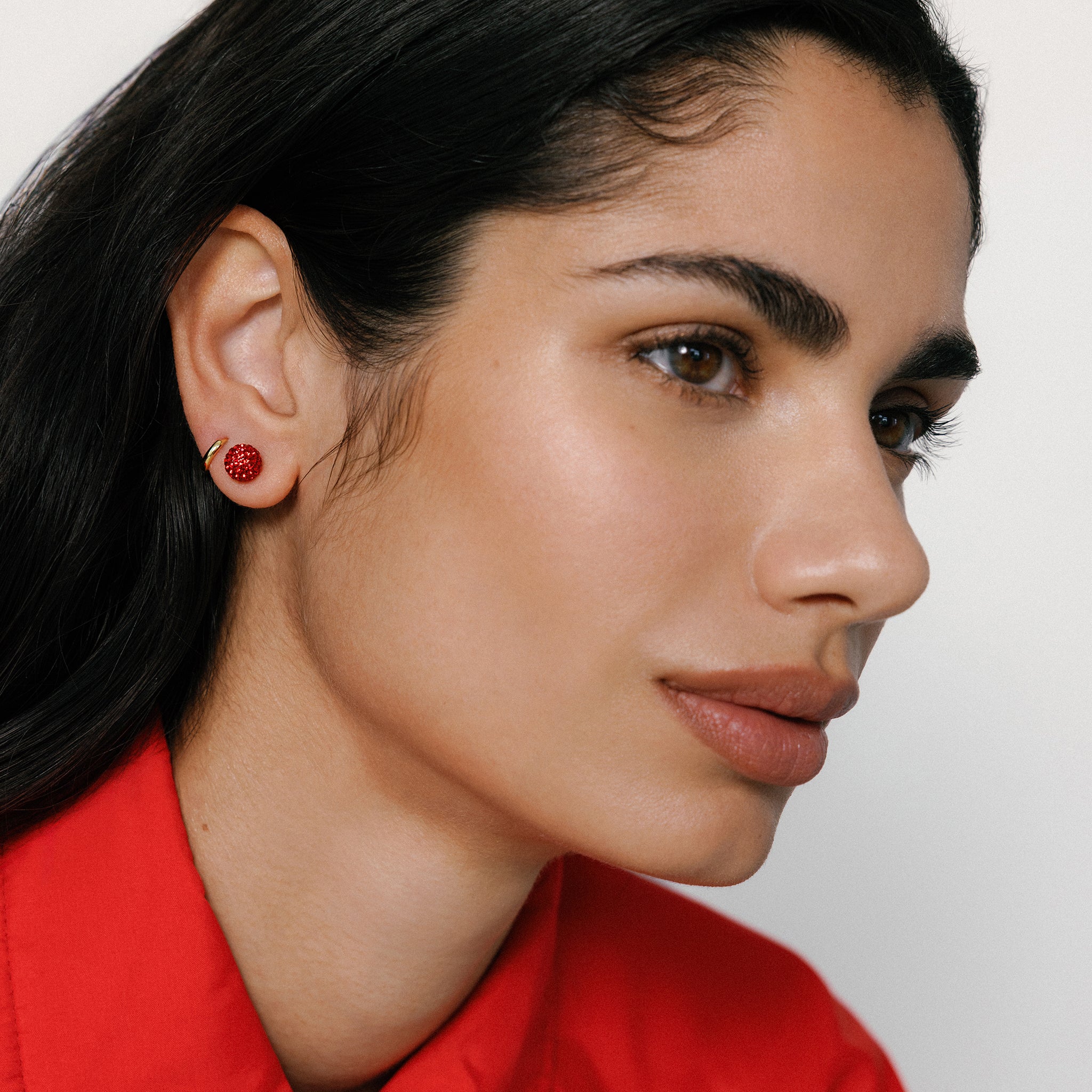Small Red Sparkle Ball™ Stud Earrings on model