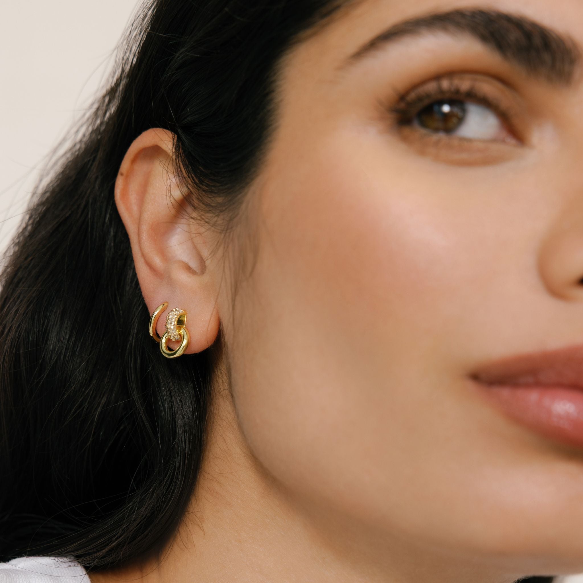 Soft Gold Interlock Sparkle Earrings on model