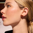 Red Velvet Sparkle Bow Stud Earrings on model