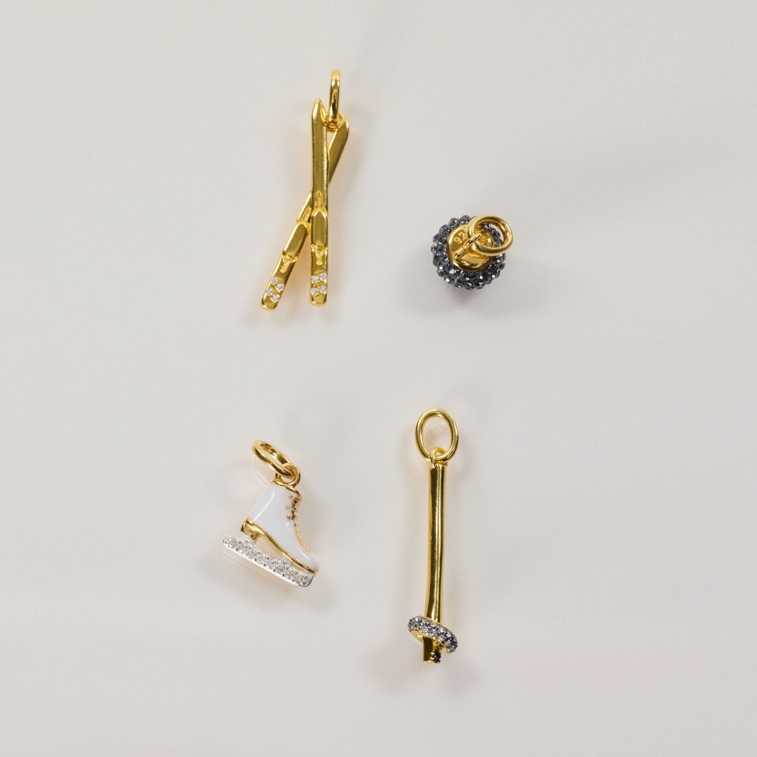 Alpine Charm, Axel Charm, Curling Rock Charm, and Ringette Charm