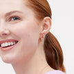 Heart Huggie Hoop Earrings Rose Gold on model